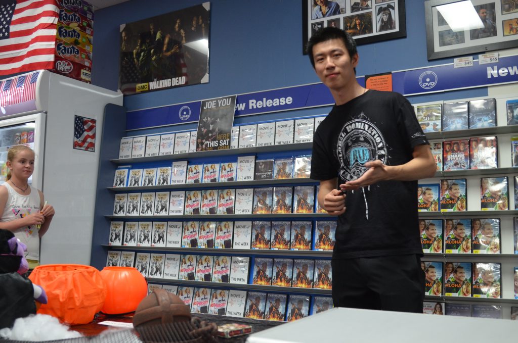 Joe You shows off his close up magic skills to the crowd at Video Ezy on Saturday night. 